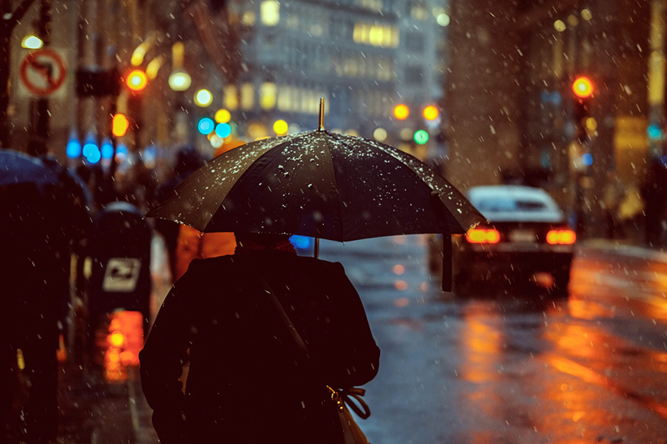 a man with umbrella, walking in the rain