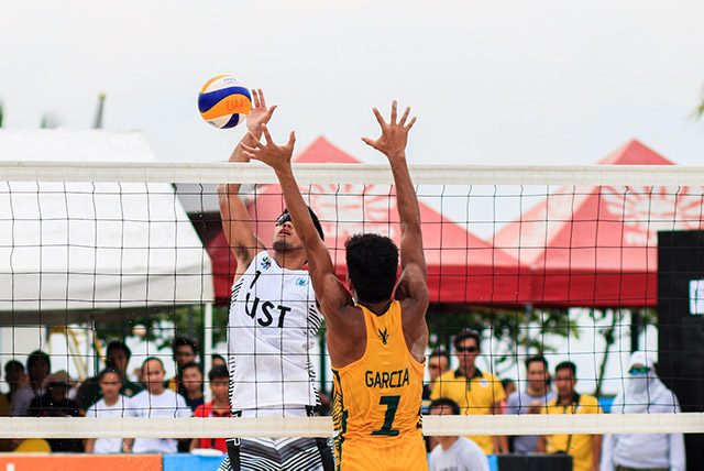 two men playing outdoor volleyball